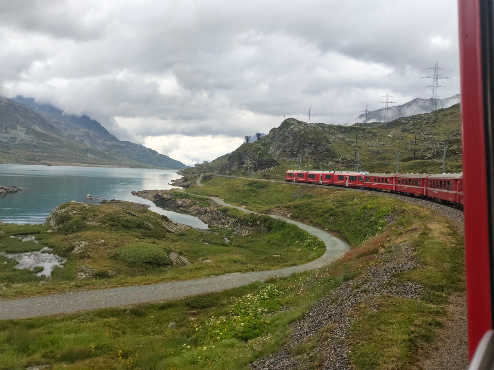The train snaking along an Alpine lake